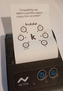 A thermal printer is printing a receipt showing compatibility percentages for different programming languages with a caption about added compatibility for printing the capture. (Captioned by AI)