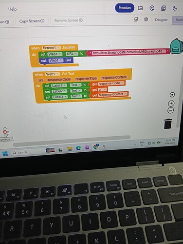 A laptop screen displays a Scratch programming interface with code blocks controlling a cat sprite's movement and events. (Captioned by AI)
